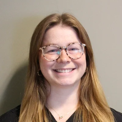 Chiropractic Kalamazoo MI Kaylee Bowling Kaylee Bowling smiling while wearing glasses.